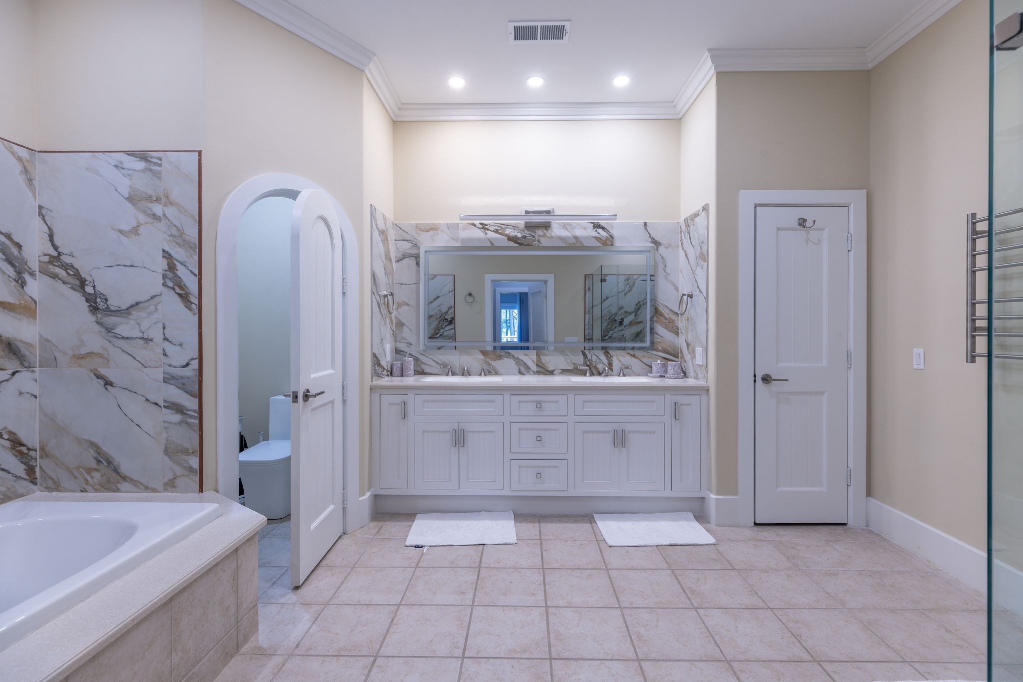 Marble primary bath with dual vanities at the estate