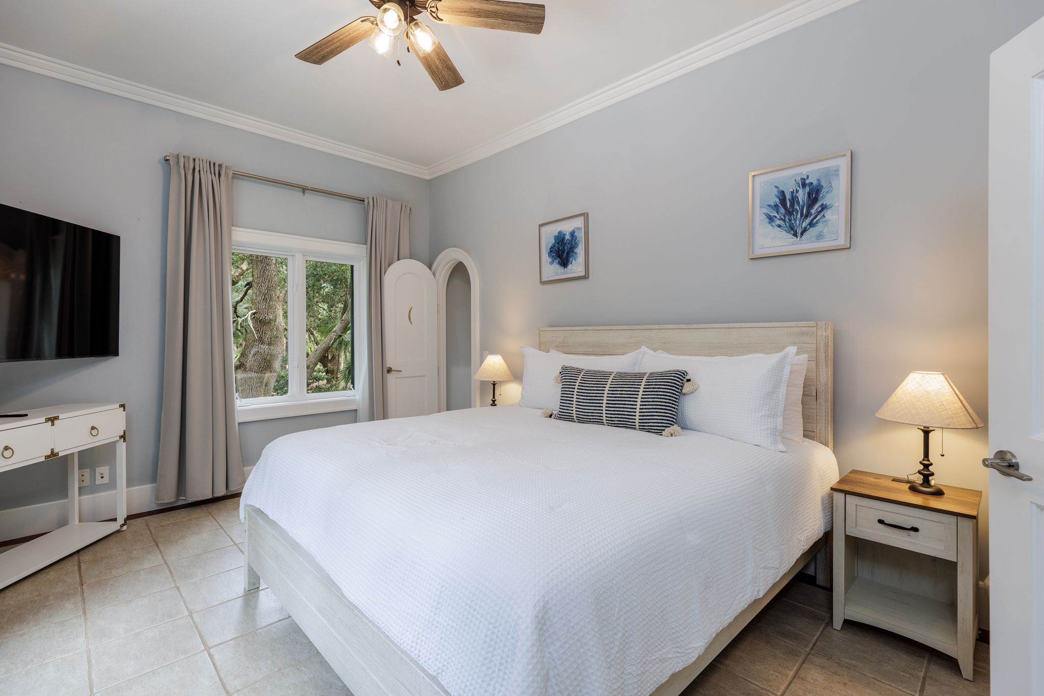 Guest suite with a king bed and calm, warm-neutral finishes