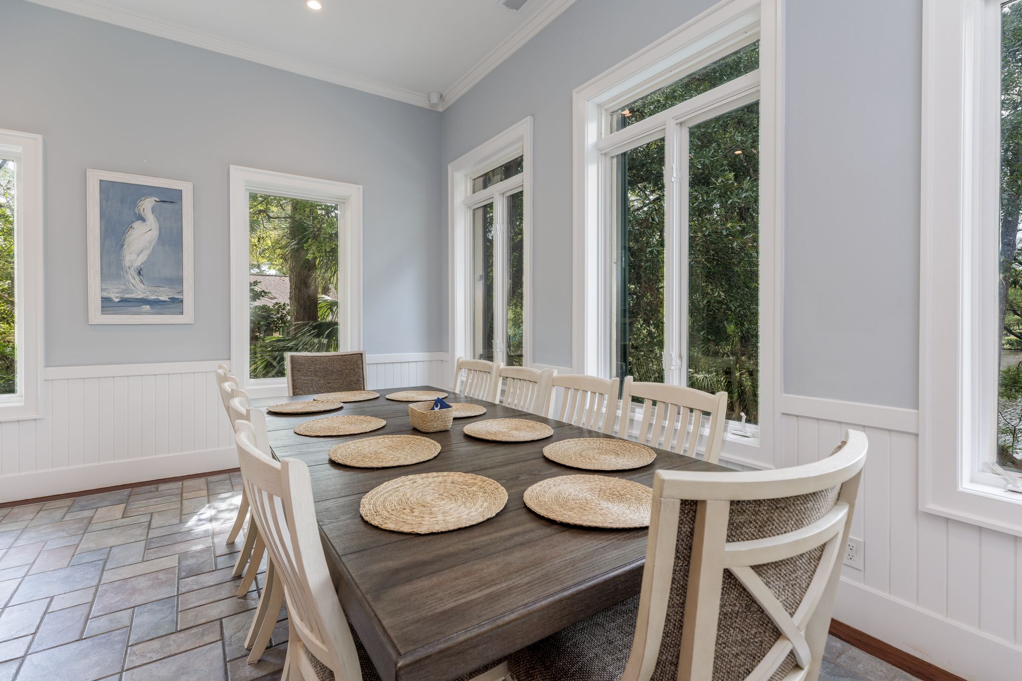 Dining space set for a large group beside the chef’s kitchen