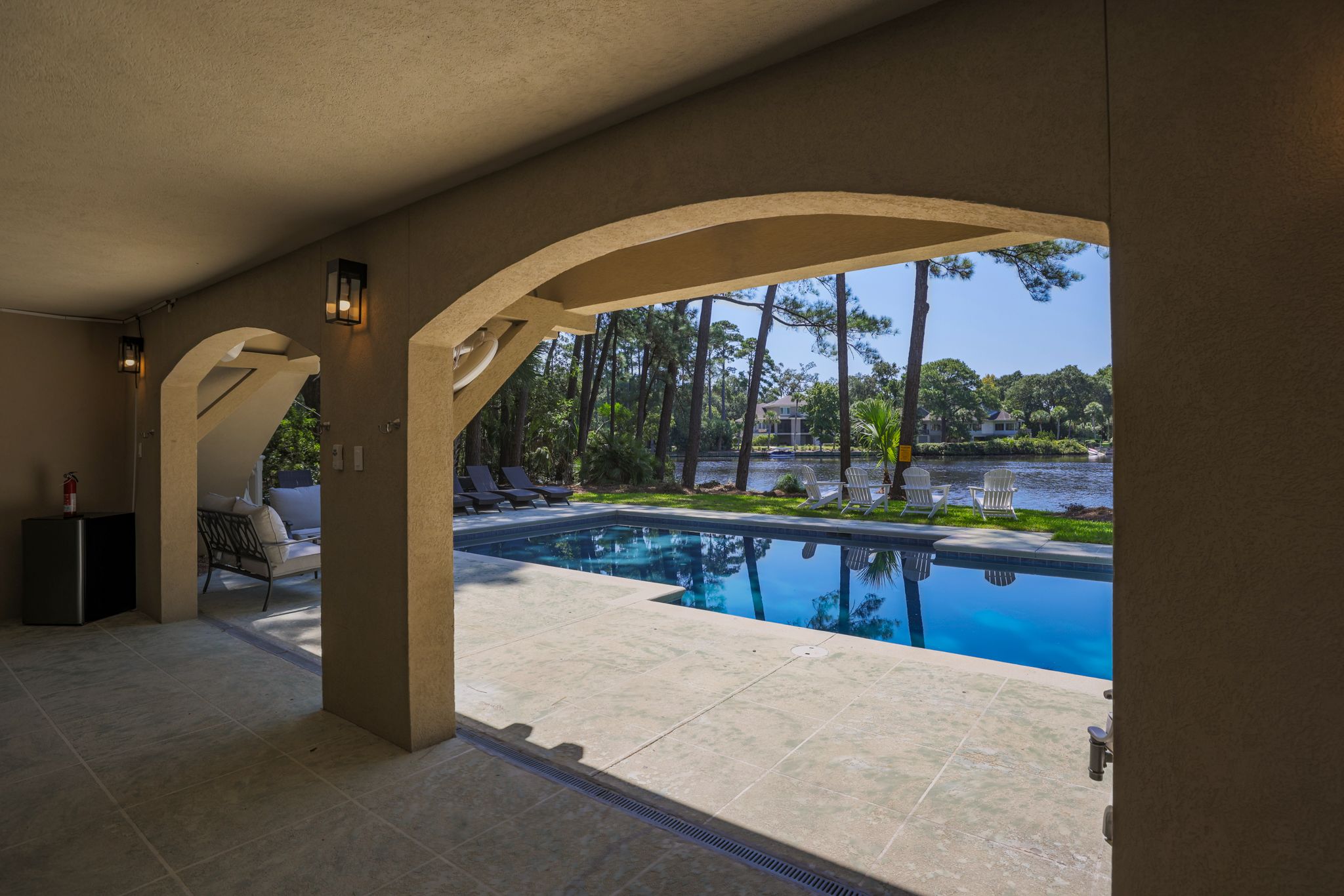 Arched lanai of the Low Country Luxury estate framing the private pool and lagoon in Palmetto Dunes, Hilton Head Island