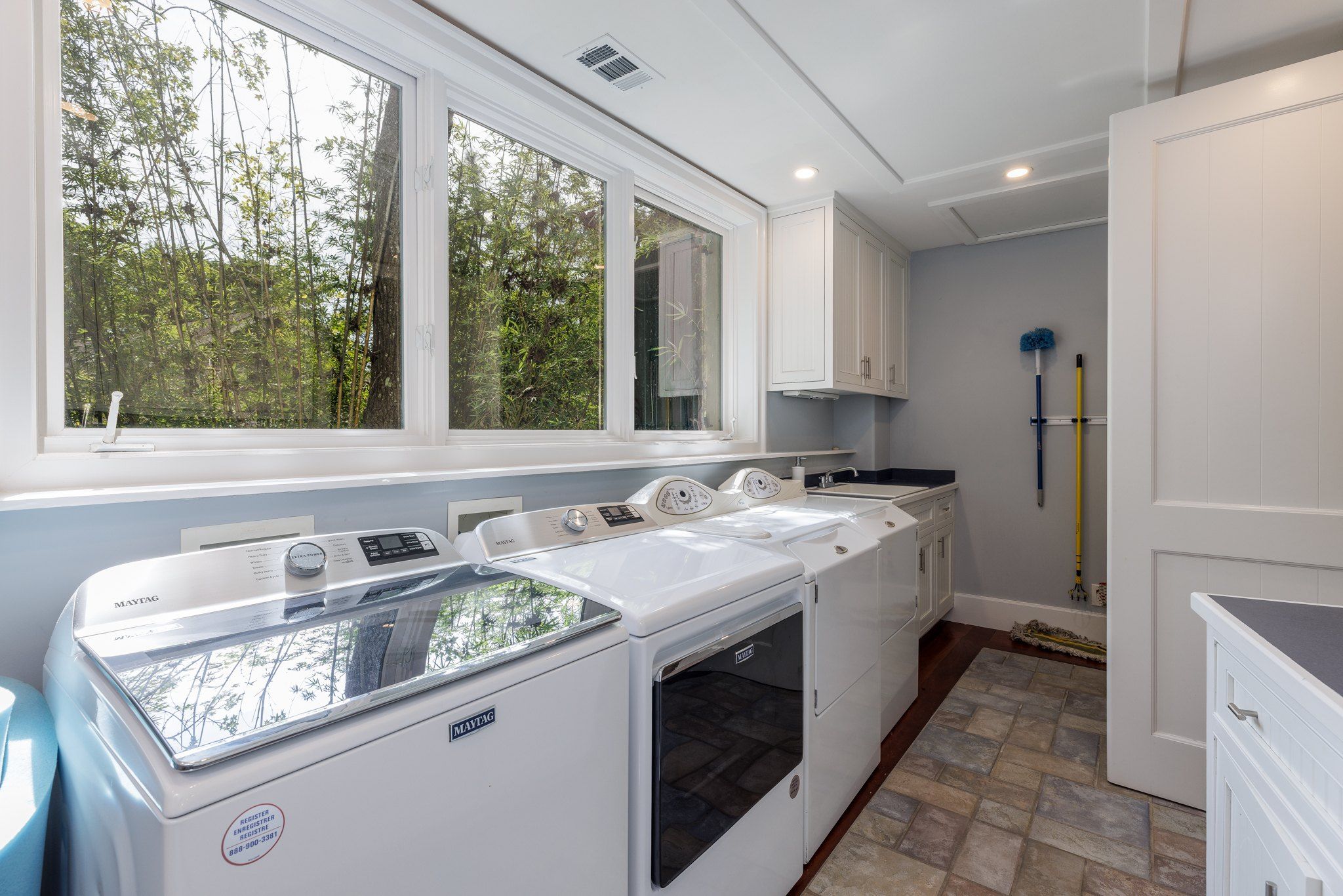 Full laundry room with side-by-side washer and dryer for long stays