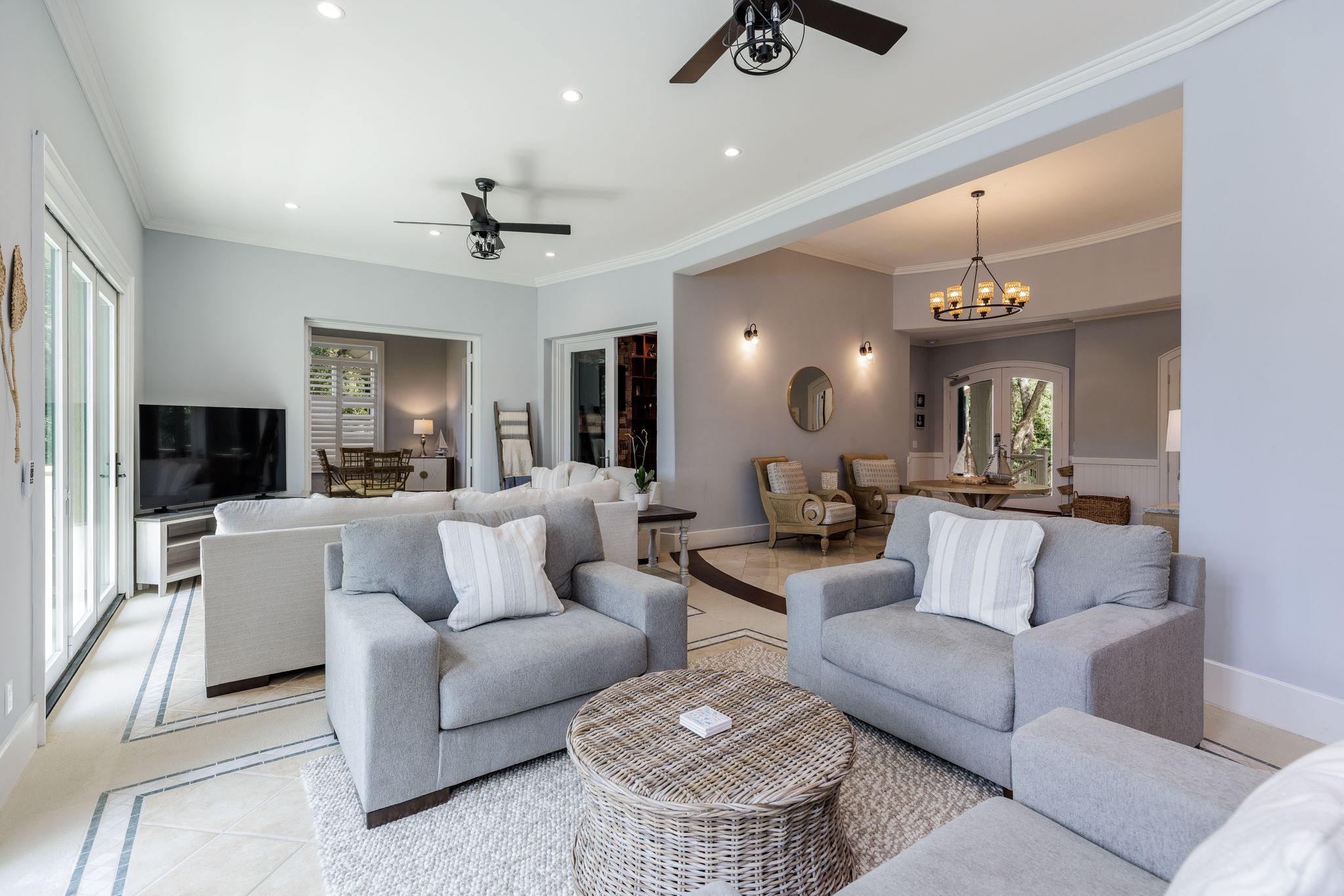 Wide great room with generous seating and a large screen for the full group