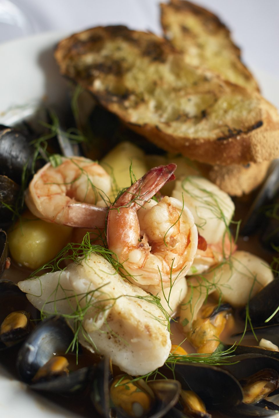 A Lowcountry seafood stew of shrimp, mussels, and white fish served with grilled bread.